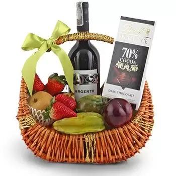 Fresh fruits, bottle of wine and chocolates