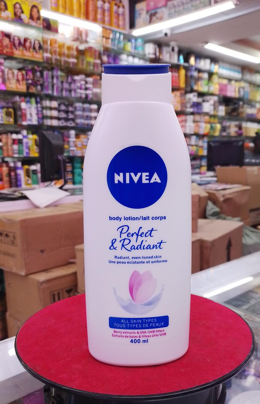 Nivea body lotion bottle on a red surface with a store shelf in the background
