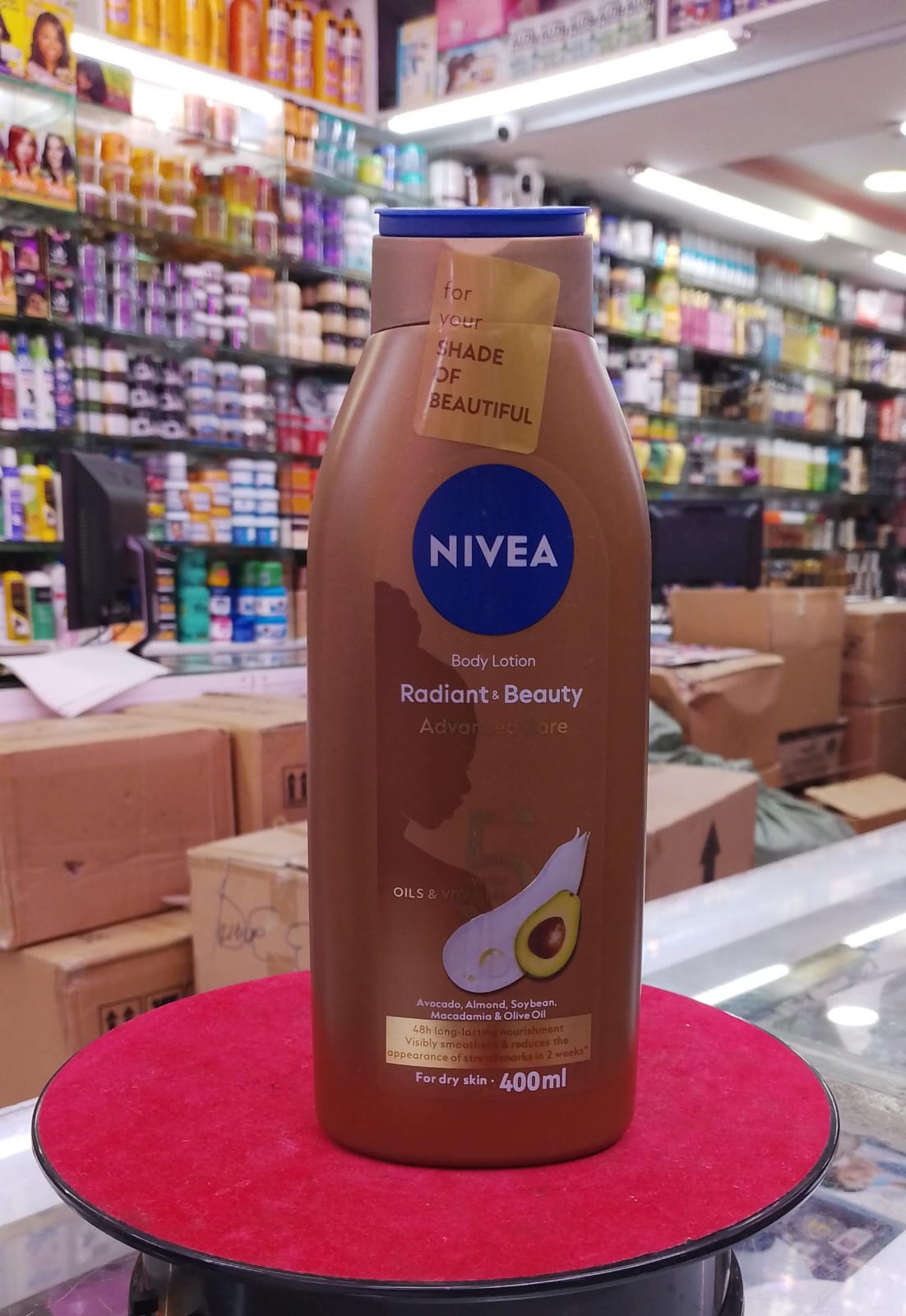 Nivea body lotion bottle on a red platform in a store setting