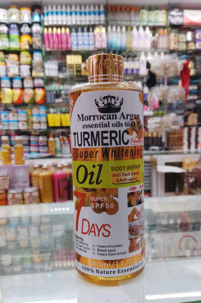 Bottle of Moroccan Argan Turmeric Super Whitening Oil with a colorful background of shelves.
