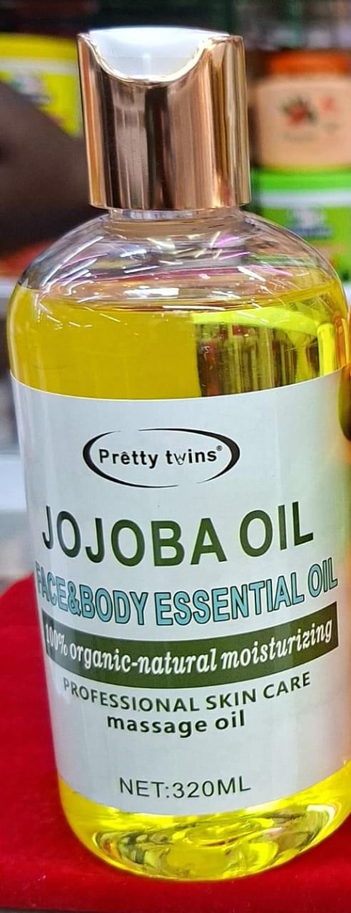 Bottle of Jojoba oil with a visible brand label on a blurred background