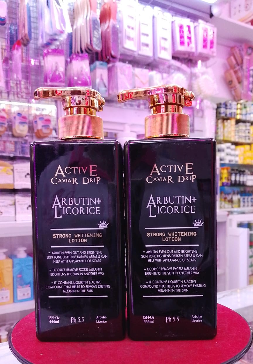 Two bottles of Active Caviar Drip with Arbutin+ Licorice on a red stand in a store setting.