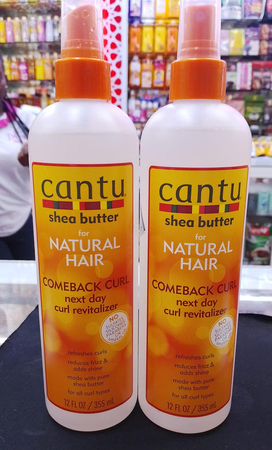 Two bottles of Cantu shea butter hair product in a store setting