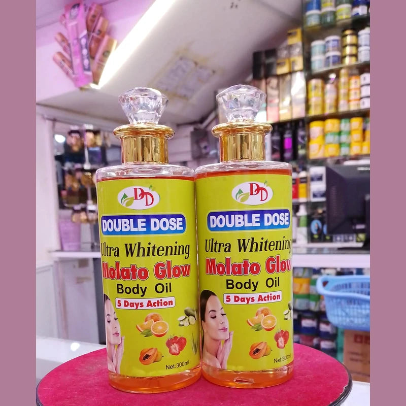 Two bottles of Double Dose Ultra Whitening Molato Glow Body Oil on a pink surface with a store background.