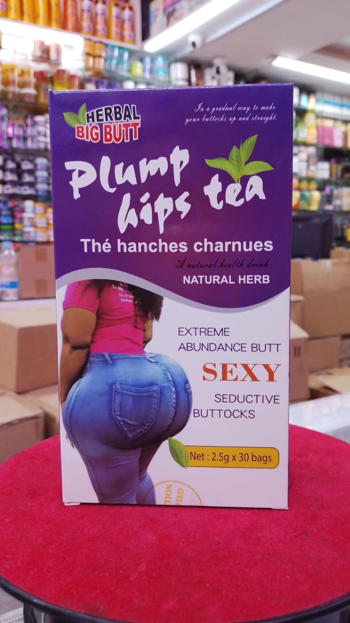Box of Herbal Big Butt Plump Hips Tea on a red surface with blurred store background