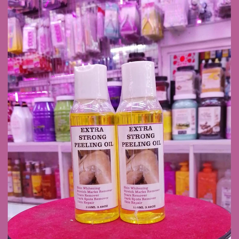 Two bottles of 'Extra Strong Peeling Oil' on a pink surface with a blurred store background.