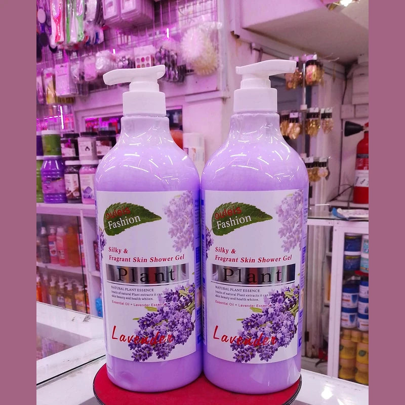 Two bottles of lavender shower gel on a stand with a store shelf in the background.
