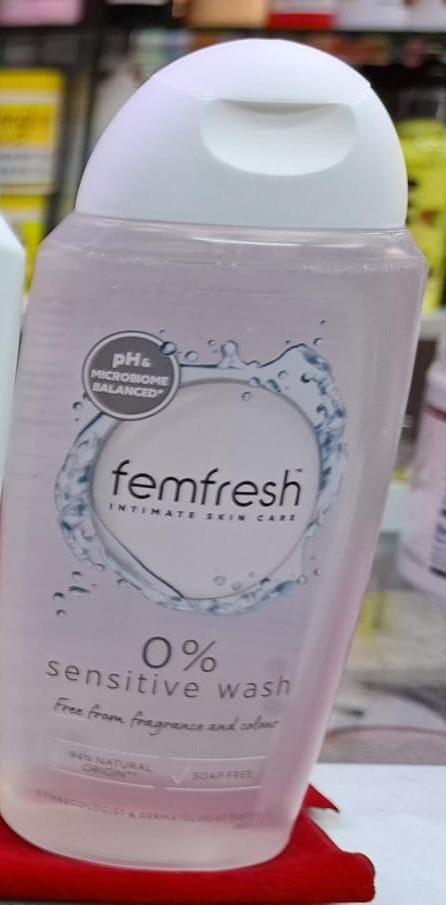 Femfresh intimate skin care product on a red surface with a blurred background