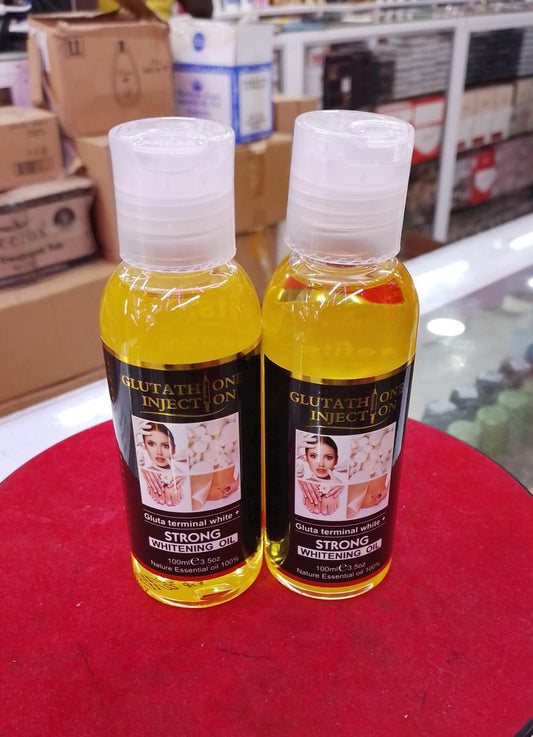 Two bottles of Glutathione Injection on a red surface with a blurred background.