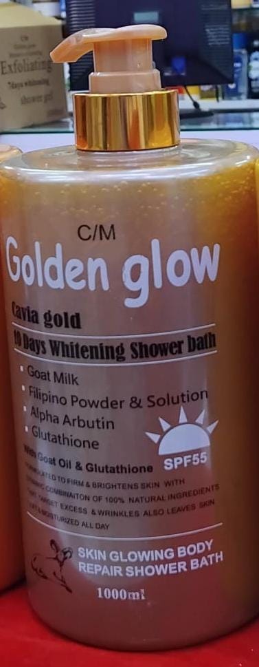 Orange bottle of 'Golden Glow' shower bath with pump on a red surface