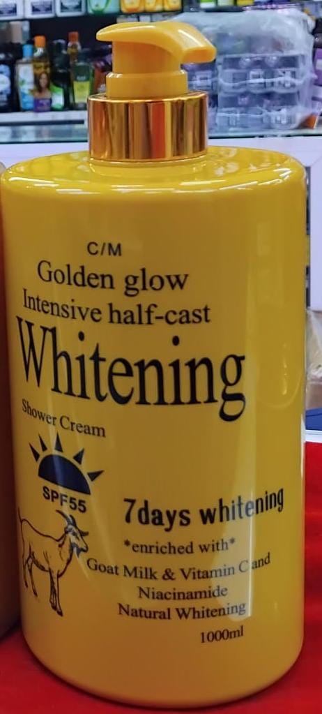 Yellow bottle of Golden Glow Whitening Shower Cream on a red background