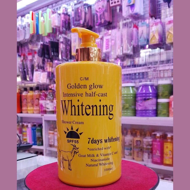 Yellow bottle of C&M Golden Glow Intensive half-cast Whitening Shower Cream with pump in a store setting.
