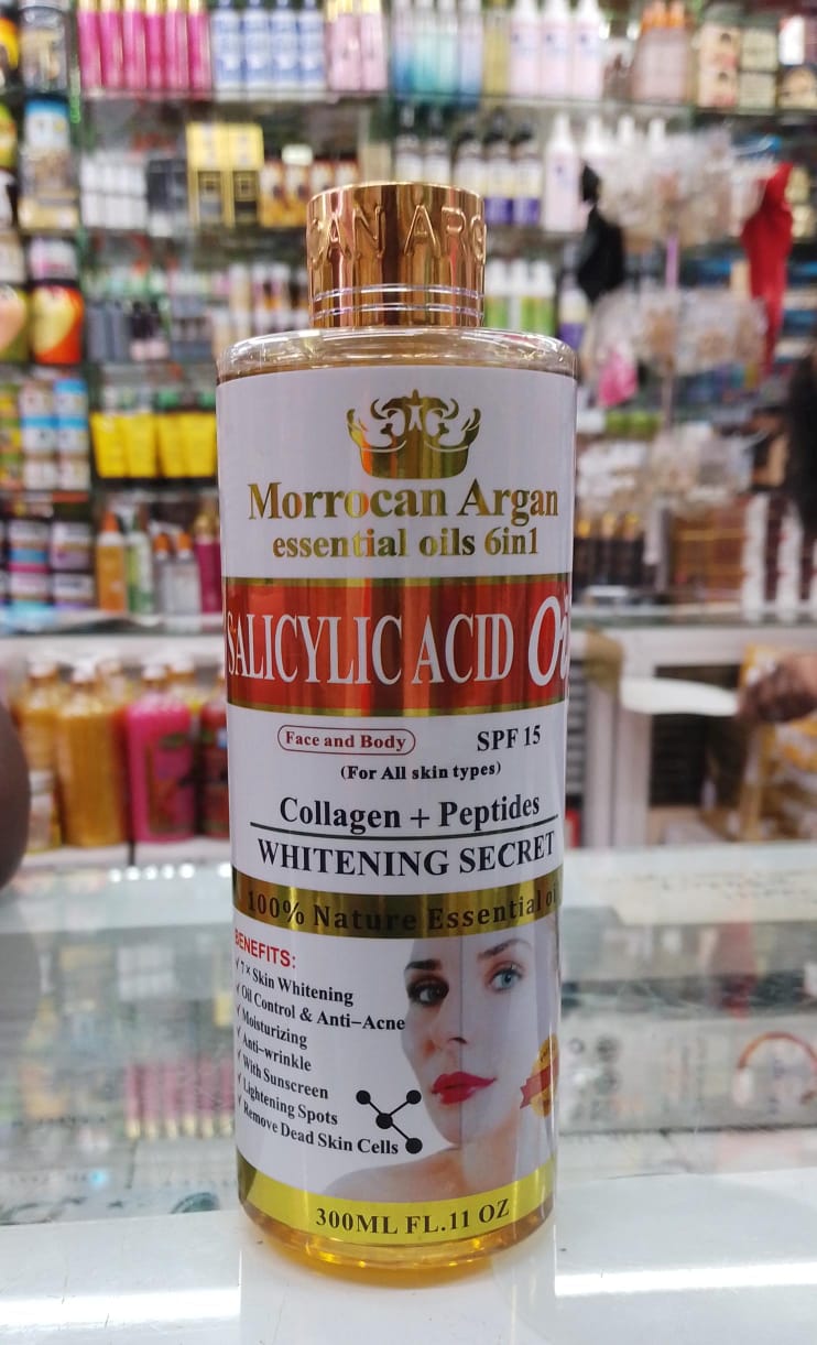 Bottle of Moroccan Argan essential oils with a label on a store shelf background