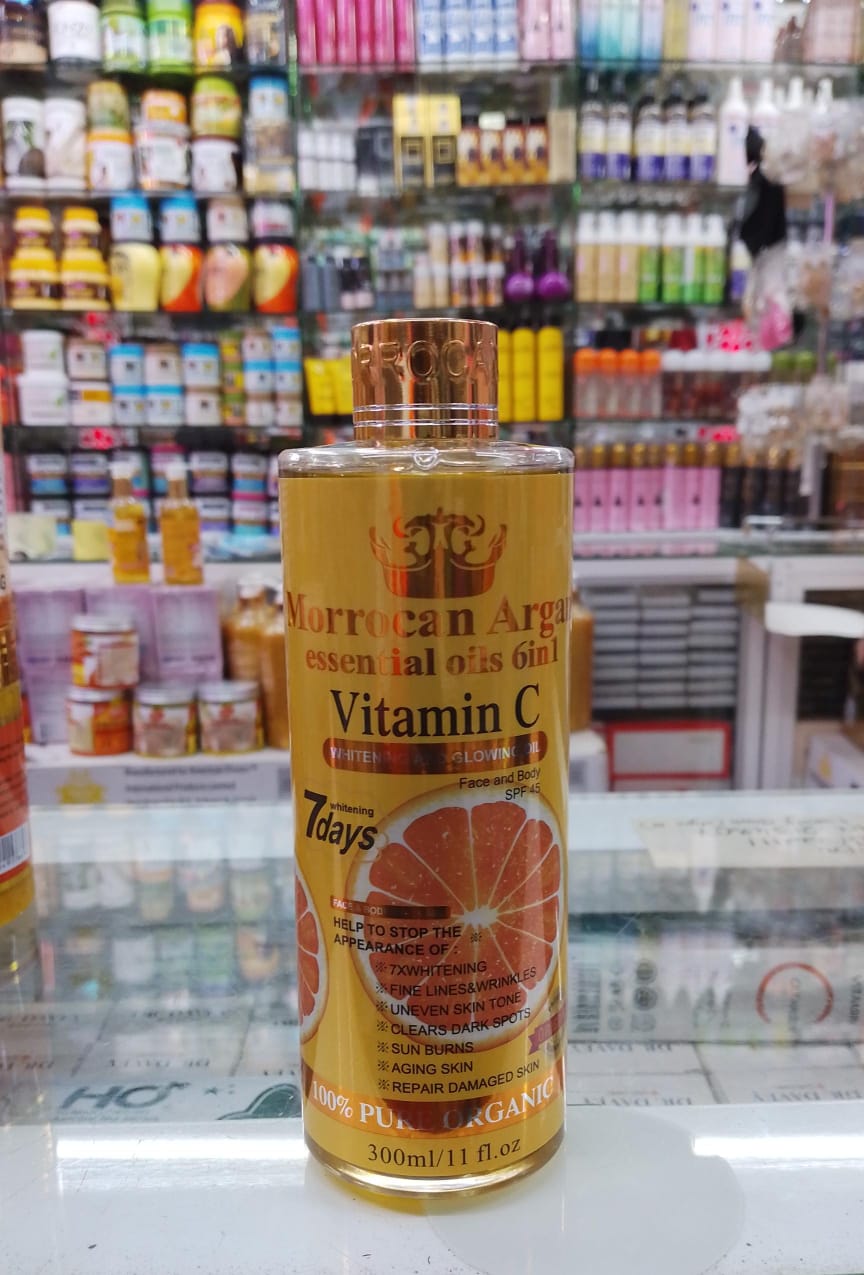 Bottle of Moroccan Argan Oil with Vitamin C on a store shelf background