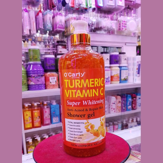 Turmeric Vitamin C shower gel bottle on a pink stand with shelves of products in the background