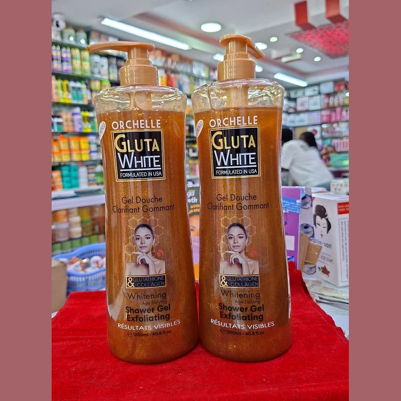 Two bottles of Orchelle Gluta White shower gel on a red surface with a store background.