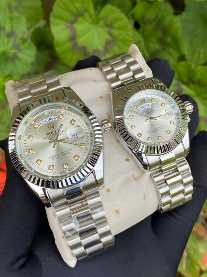 ROLEX COUPLE WATCHES SINGLE PIECE DAY AND DATE DISPLAY WATER RESISTANT BATTERY POWERED ENQUIRIES