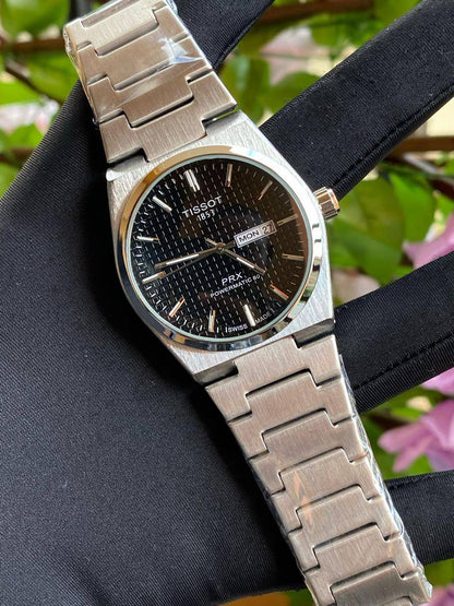 TISSOT DAY & DATE BATTERY POWERED WATER RESISTANT DAY & DATE DISPLAY STAINLESS STEEL FINISH ENGRAVING SERVICES ENQUIRIES