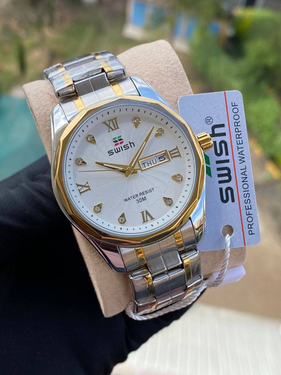 SWISH GENTS WATCH DAY&DATE DISPLAY BATTERY POWERED STAINLESS STEEL WATER RESISTANT TWO-TONE GOLDSILVER ENQUIRIES