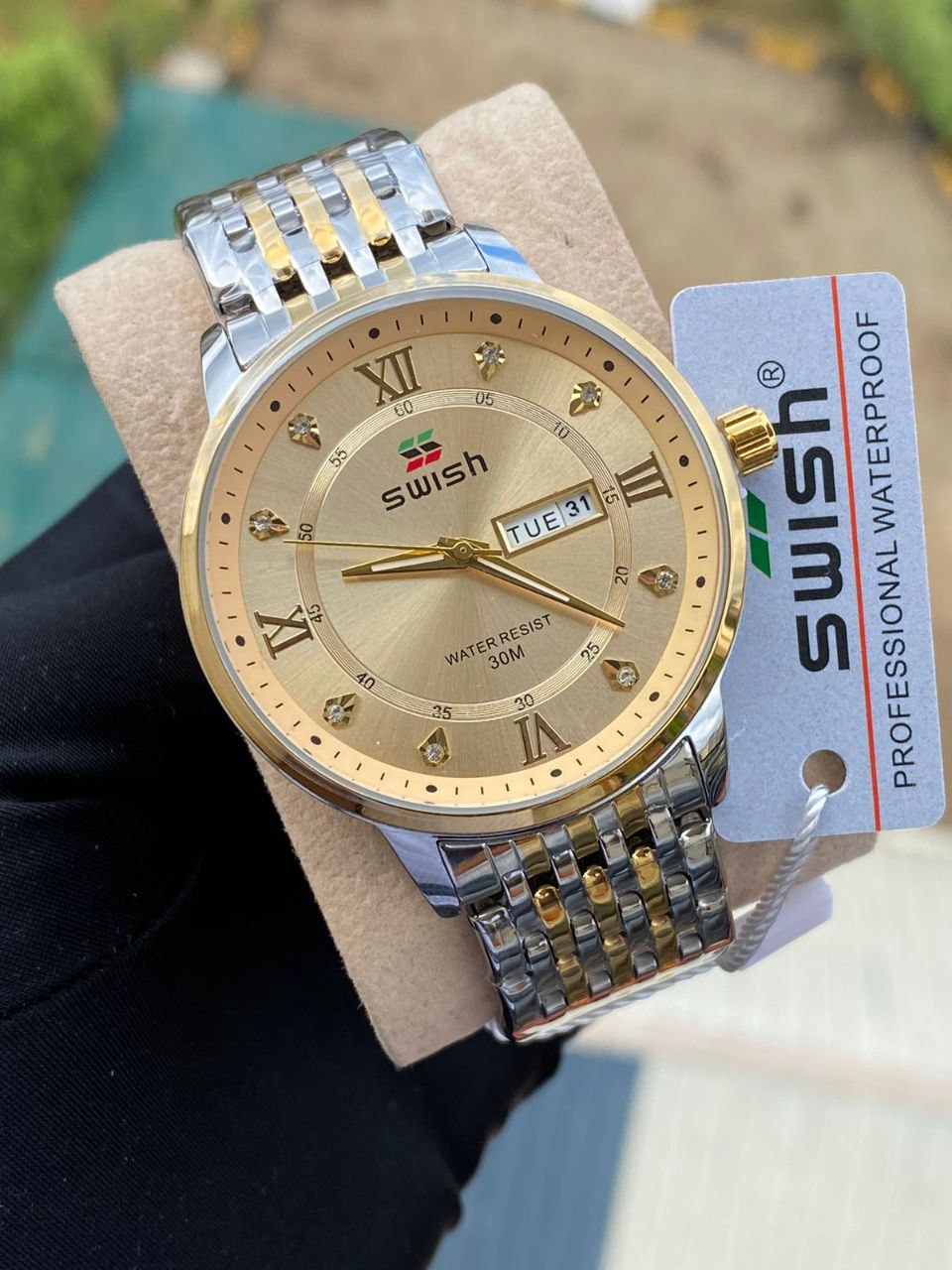 SWISH GENTS WATCH DAY&DATE DISPLAY BATTERY POWERED STAINLESS STEEL WATER RESISTANT TWO-TONE GOLDSILVER ENQUIRIES