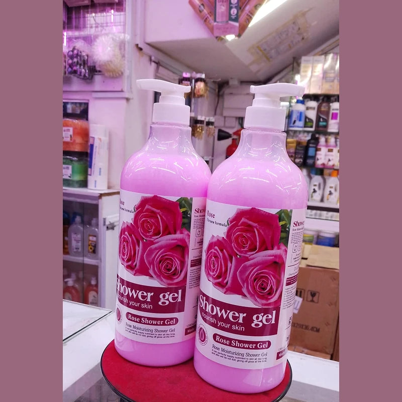 Two bottles of rose shower gel on a shelf in a store.
