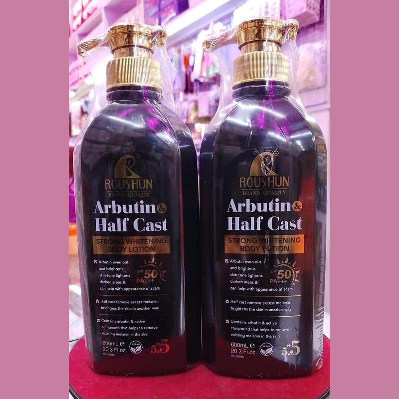 Two bottles of Roushun Arbutin Half Cast body lotion on a pink background