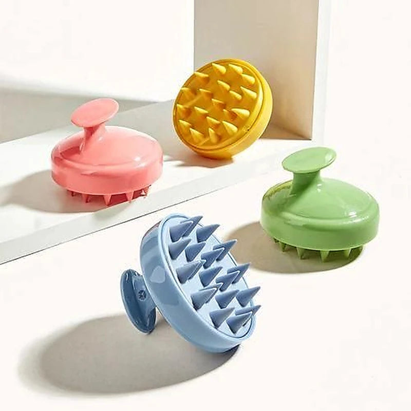 Four colorful scalp massagers on a light surface