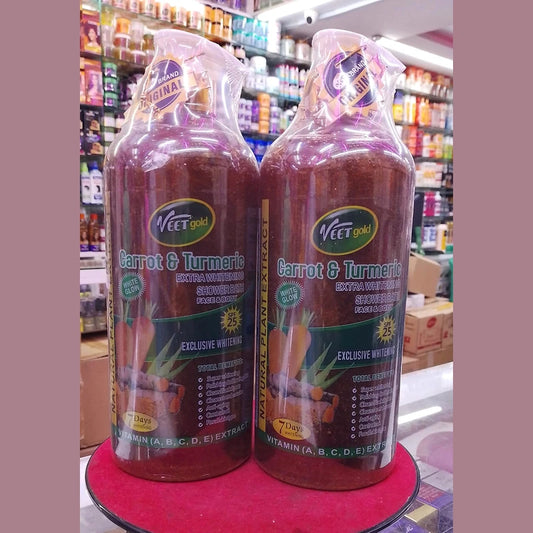 Two bottles of 'Veet Gold Carrot & Turmeric' product on a red stand with a store shelf in the background.