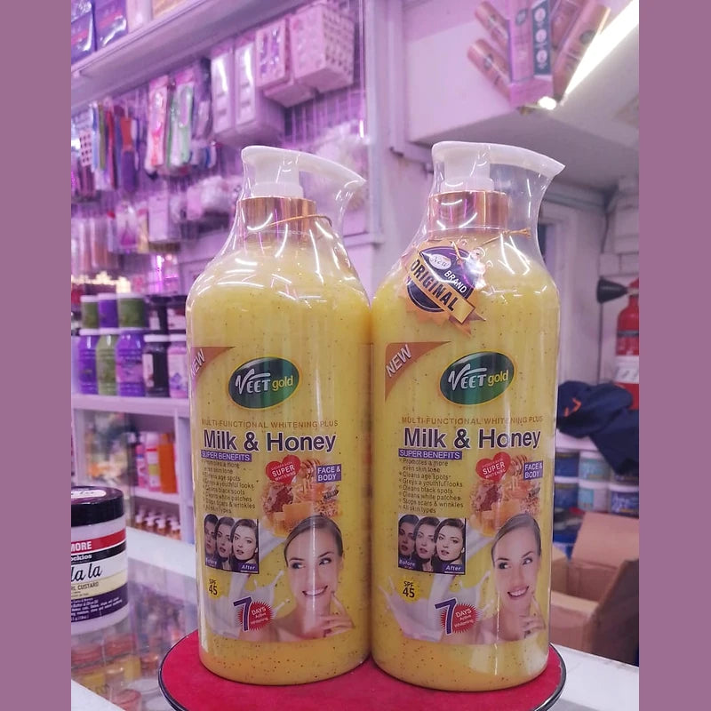Two bottles of 'Milk & Honey' product on a red stand with a store shelf in the background.
