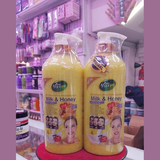 Two bottles of 'Milk & Honey' product on a red stand with a store shelf in the background.