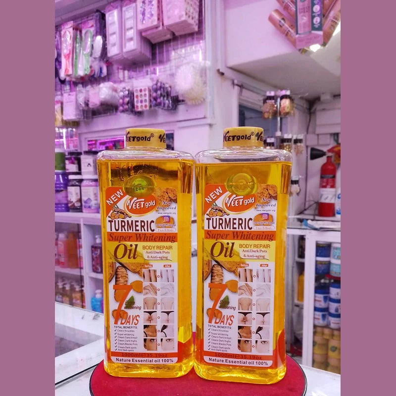 Two bottles of 'New Veet Gold Turmeric Super Whitening Oil' on a red stand with a store shelf in the background.