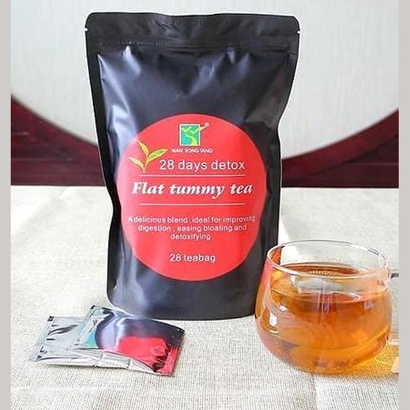 Tea package labeled '28 days detox Flat tummy tea' with a glass of tea on a textured surface.